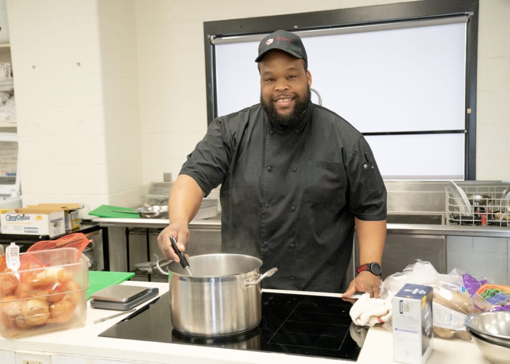 Student stirring cooking pot