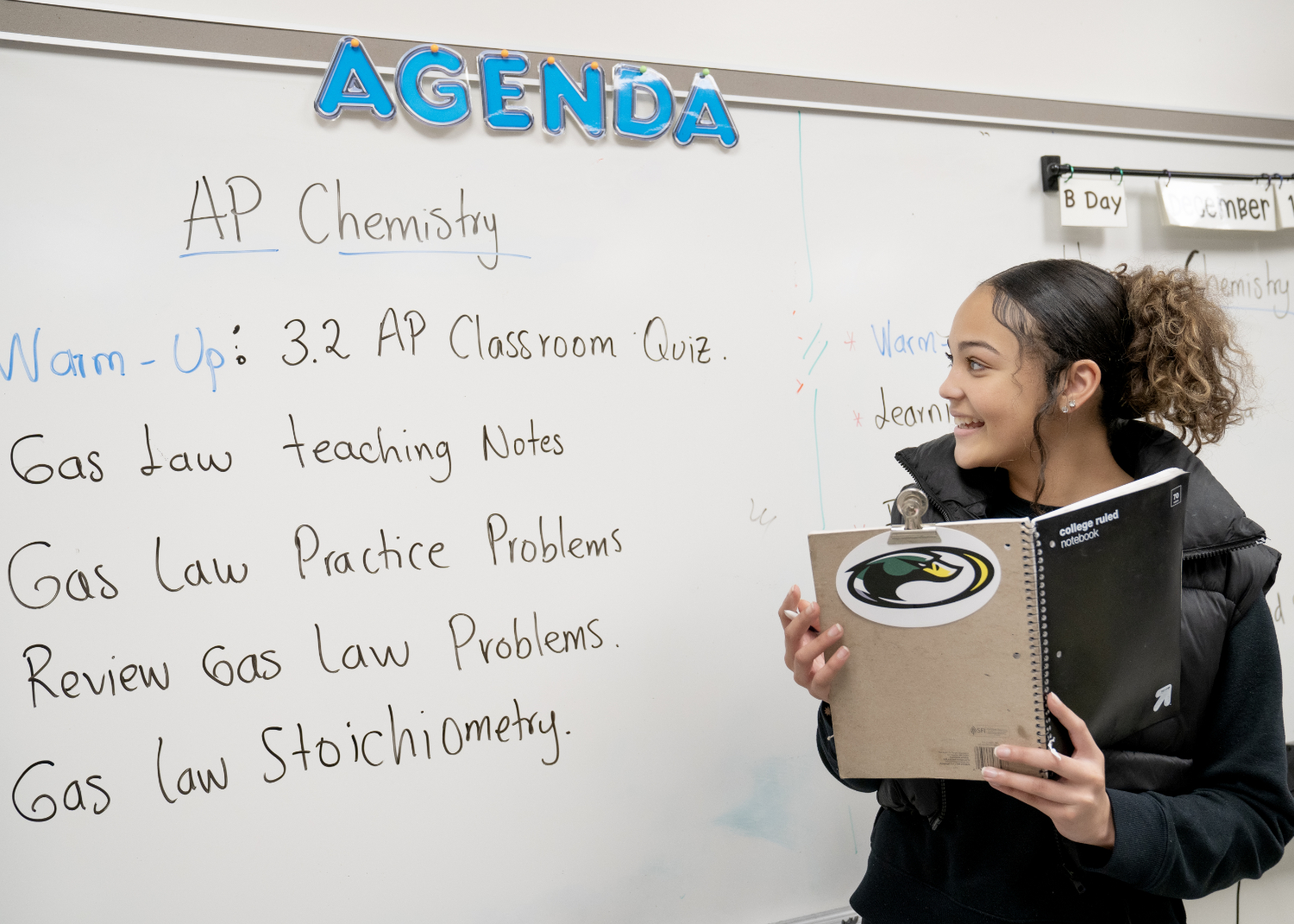 Student at whiteboard showing AP Chemistry agenda